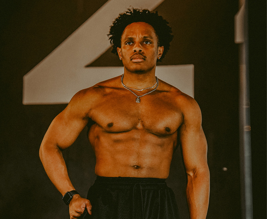 The coach posing shirtless.